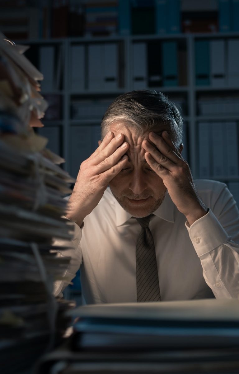 Desperate businessman working late Desperate businessman working late